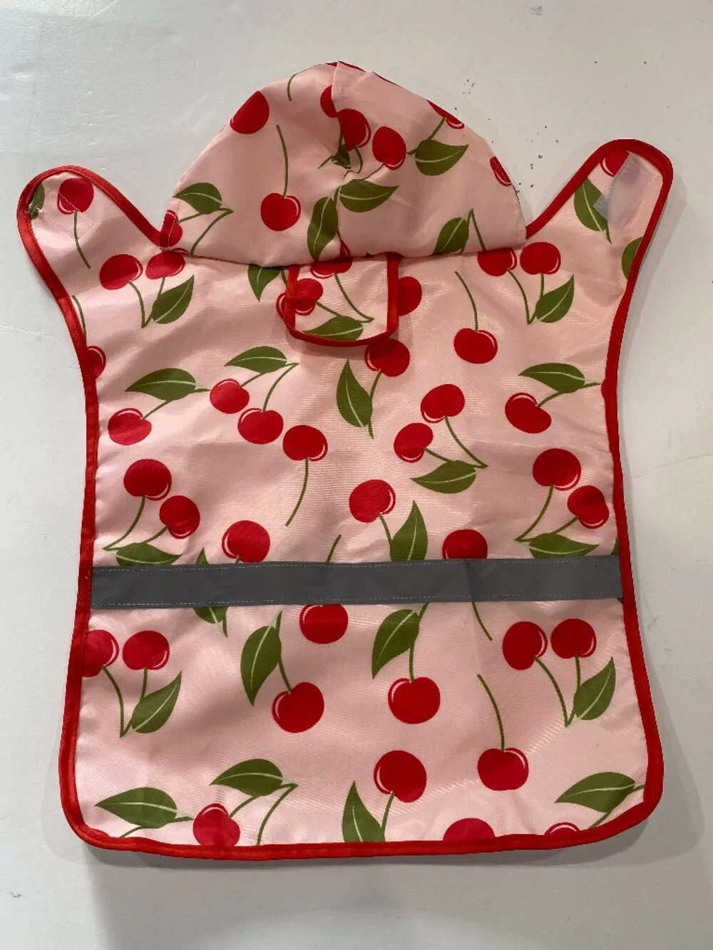 Cherry NWOT small dog raincoat with hood and reflective strip.